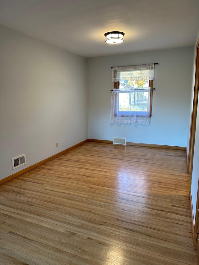 spare room with light hardwood / wood-style flooring