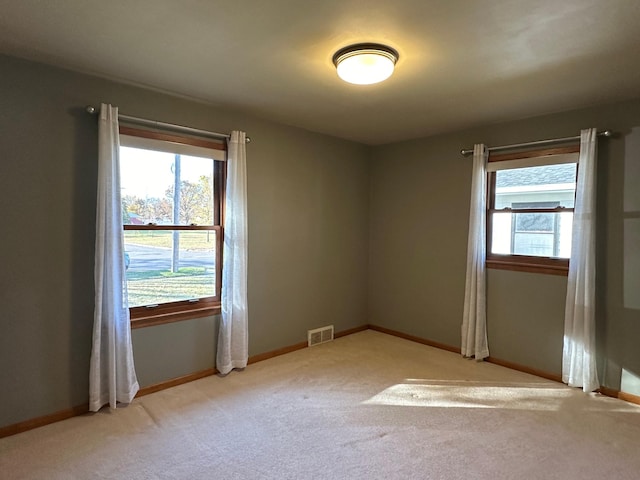 unfurnished room featuring light colored carpet