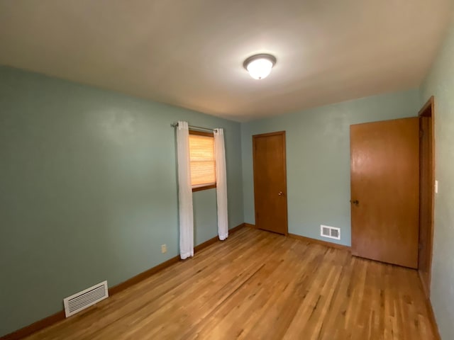 unfurnished bedroom featuring a closet and light hardwood / wood-style flooring