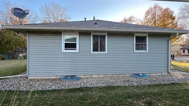 view of property exterior with a yard