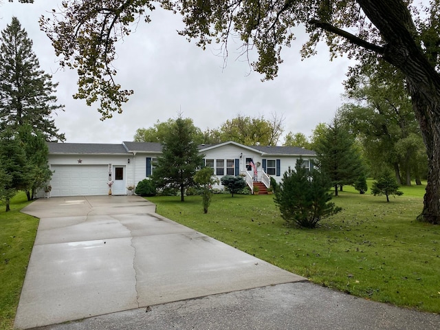 single story home featuring a garage and a front lawn