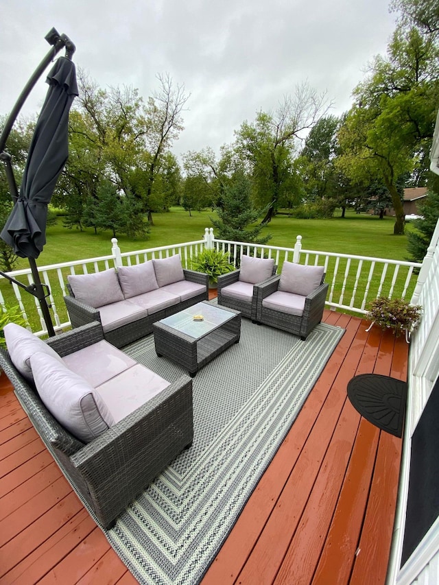 wooden deck featuring an outdoor living space and a yard