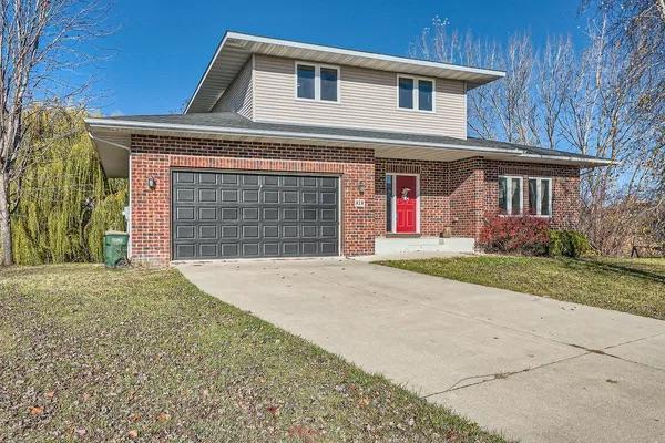 view of property with a garage and a front yard