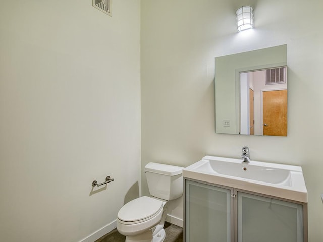 bathroom featuring toilet and vanity