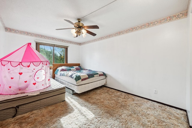 bedroom featuring ceiling fan, carpet, and a textured ceiling