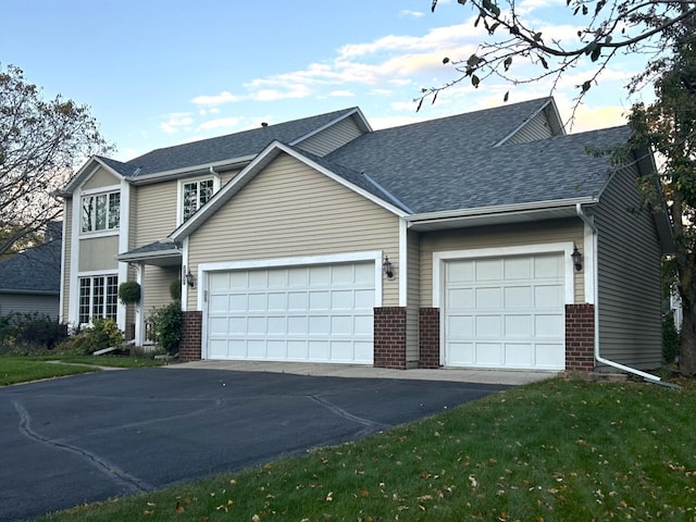 view of property with a front lawn and a garage