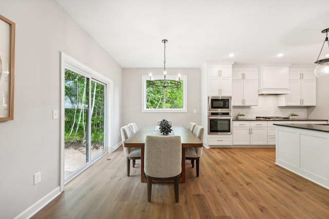 dining room with a chandelier and light wood-type flooring