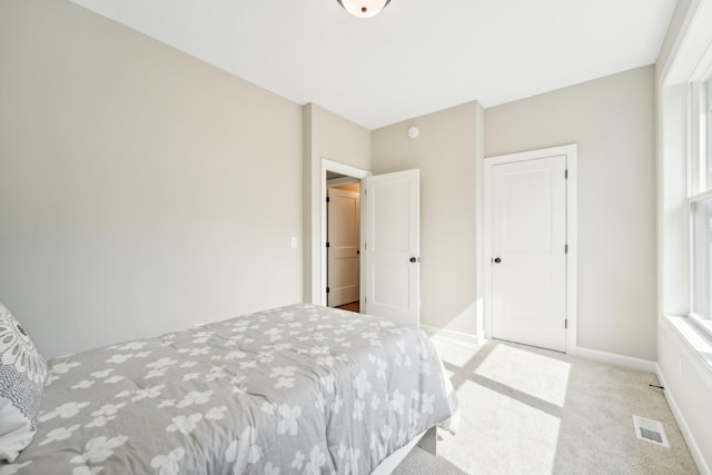 bedroom with light colored carpet