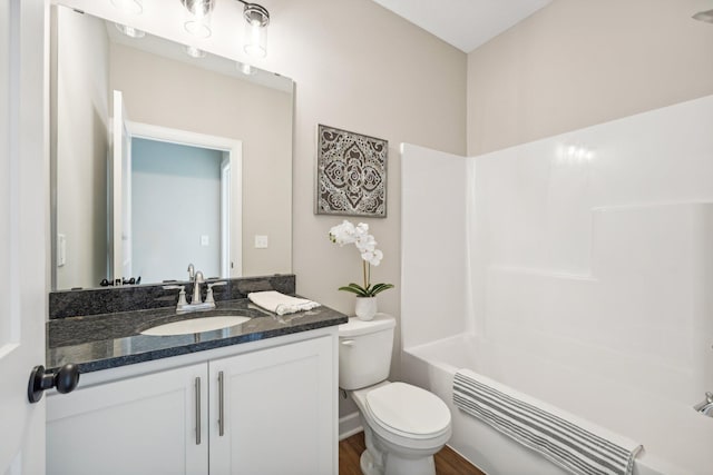 full bathroom with shower / washtub combination, hardwood / wood-style flooring, radiator, toilet, and vanity