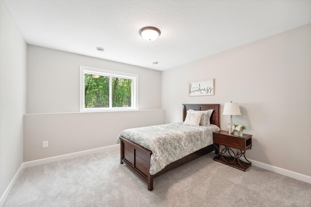 bedroom with light colored carpet