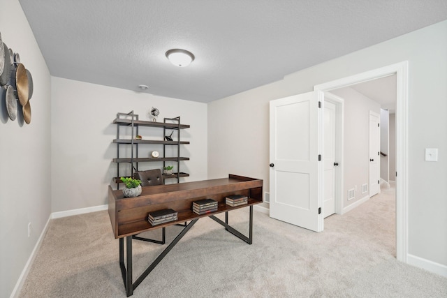 carpeted office with a textured ceiling