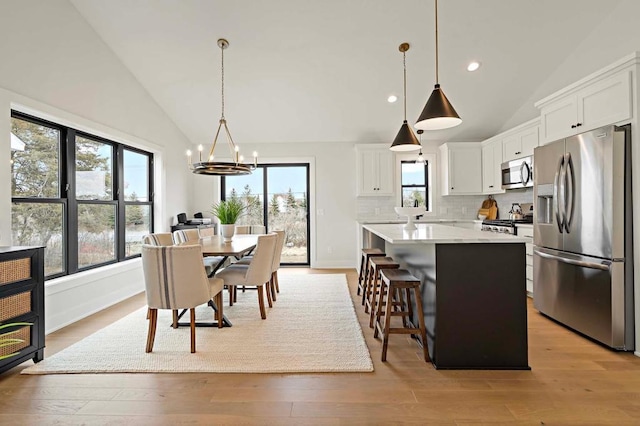 dining room featuring plenty of natural light, a chandelier, and light wood-type flooring