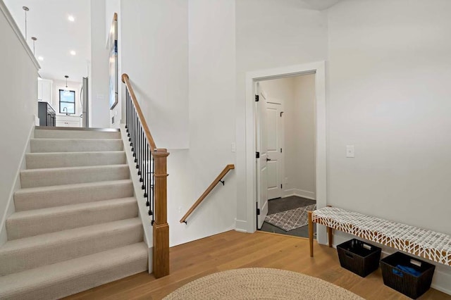 stairs featuring wood-type flooring