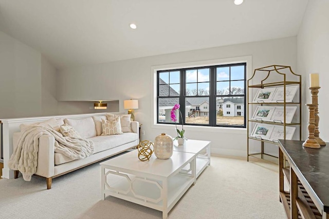 living room with light colored carpet and vaulted ceiling