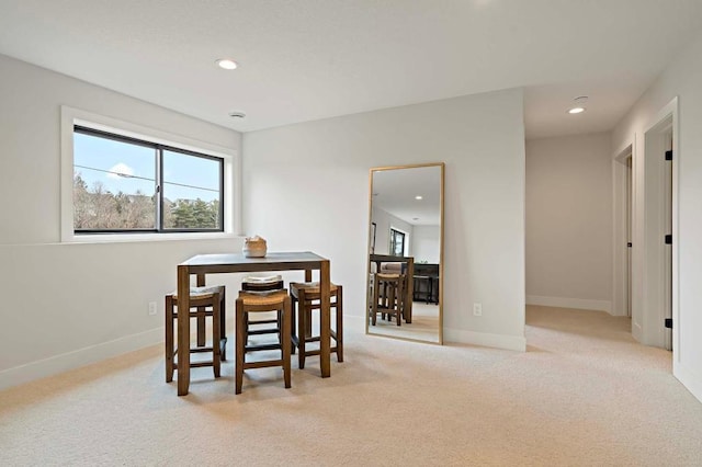 dining space with light colored carpet