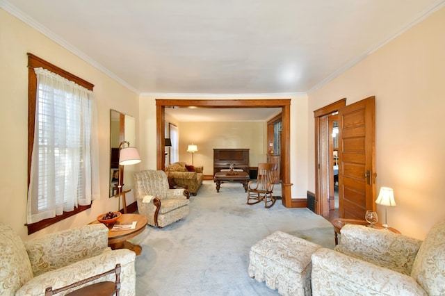 carpeted living area featuring baseboards and ornamental molding