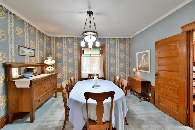 carpeted dining area with ornamental molding