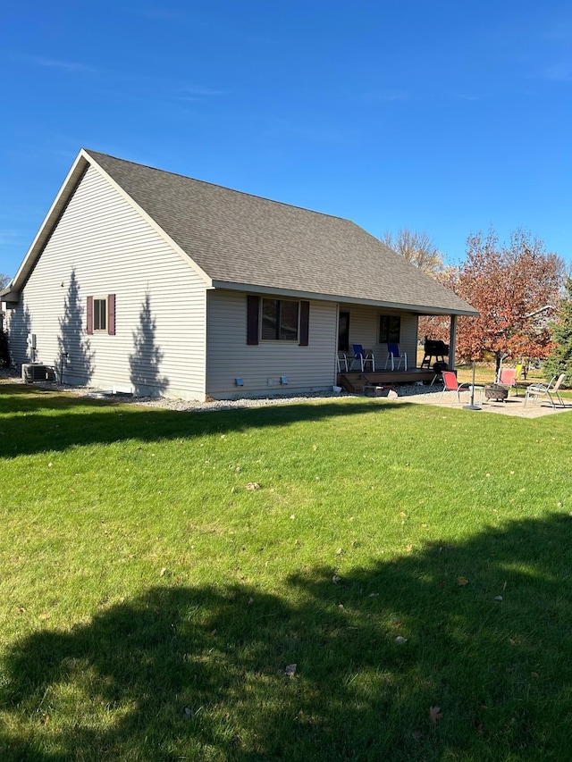 2501 Le Homme Dieu Vw NE, Alexandria, MN 56308 - back of property with a lawn, a fire pit, a patio area, and central AC unit