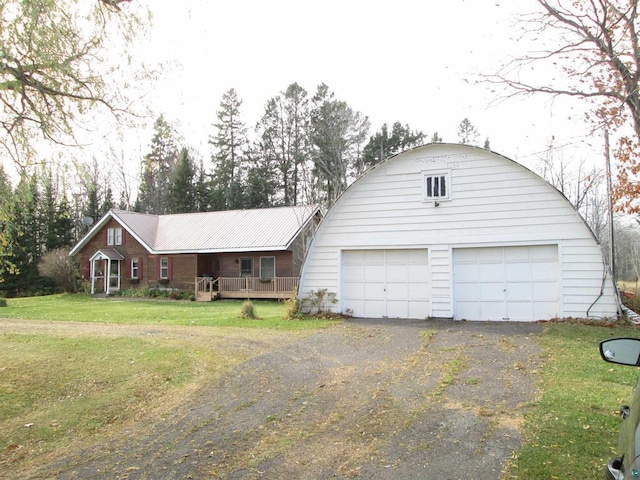 ranch-style home with covered porch, a front yard, and a garage