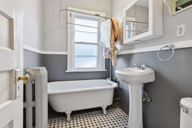 bathroom with a bath, toilet, and sink