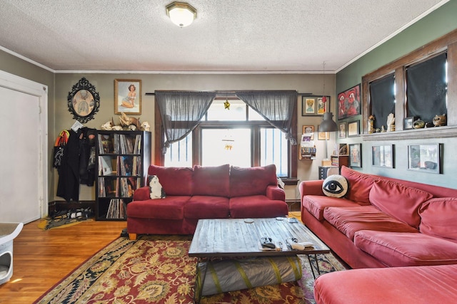 living room with crown molding, hardwood / wood-style floors, and a textured ceiling