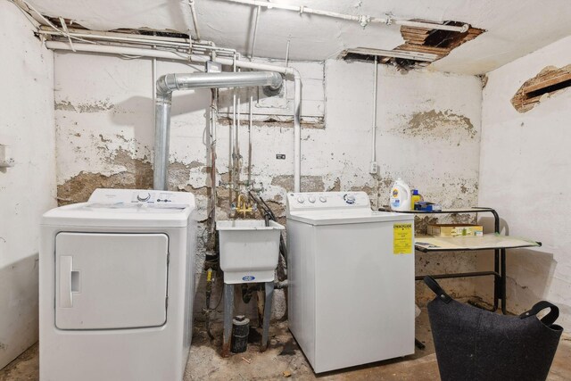 laundry room featuring washing machine and dryer and sink