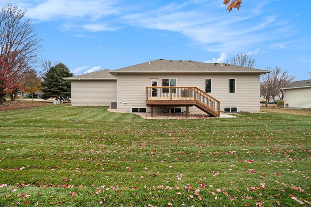 rear view of house with a yard and a deck