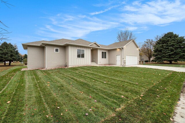 ranch-style house with a front yard and a garage