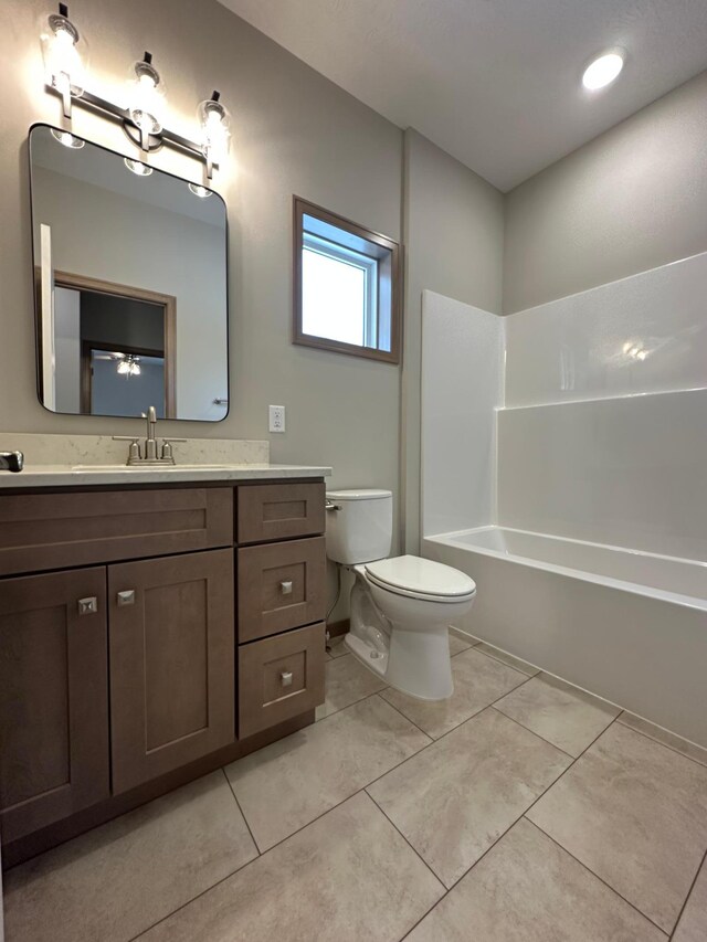 full bathroom featuring tile patterned floors, vanity,  shower combination, and toilet