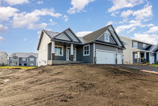 view of front of house featuring a porch and a garage