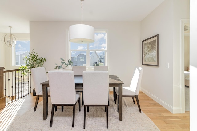 dining space with an inviting chandelier and wood-type flooring