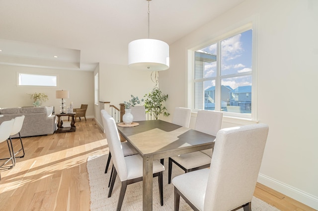 dining space with a wealth of natural light and light hardwood / wood-style floors