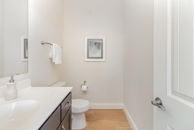 bathroom with vanity, hardwood / wood-style floors, and toilet