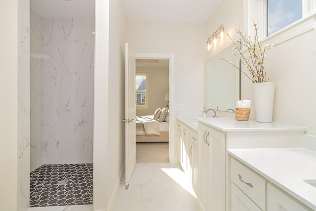 bathroom with vanity and tiled shower