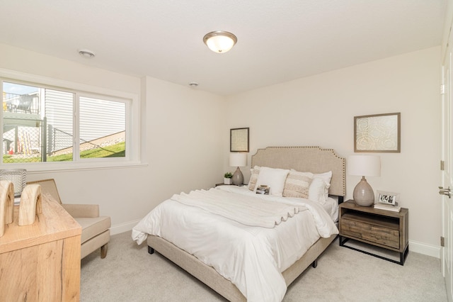 bedroom featuring light carpet