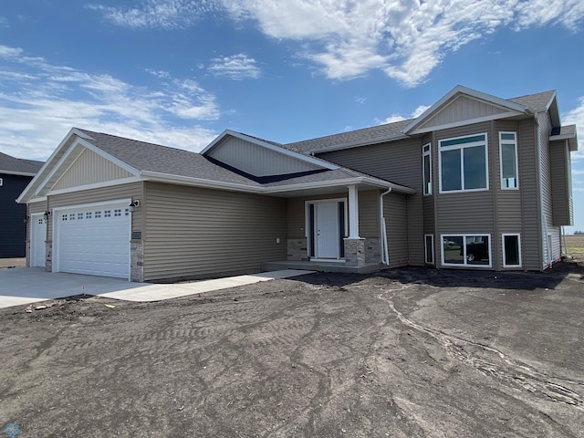 1312 Southview Dr SW, Glyndon, MN 56547 - tri-level home with stone siding, concrete driveway, roof with shingles, and a garage