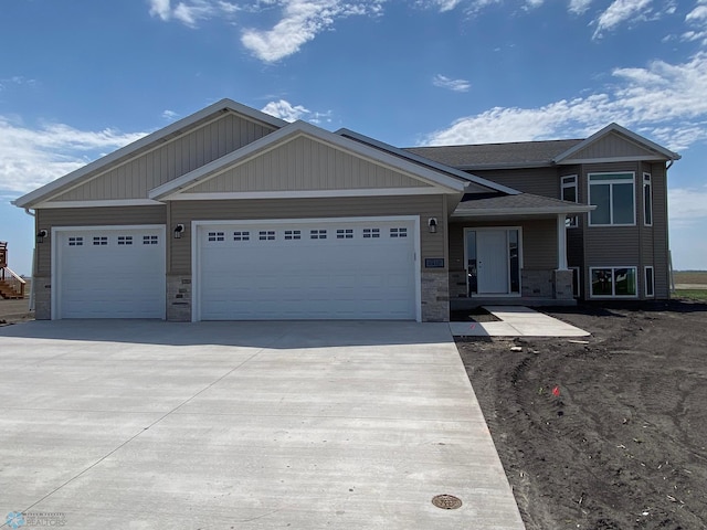 1312 Southview Dr SW, Glyndon, MN 56547 - view of front of home featuring driveway, an attached garage, and stone siding
