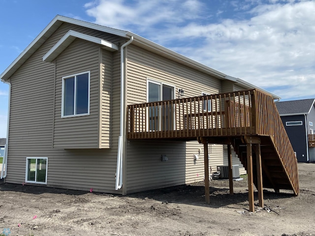 1312 Southview Dr SW, Glyndon, MN 56547 - rear view of house with a wooden deck, central AC unit, and stairs