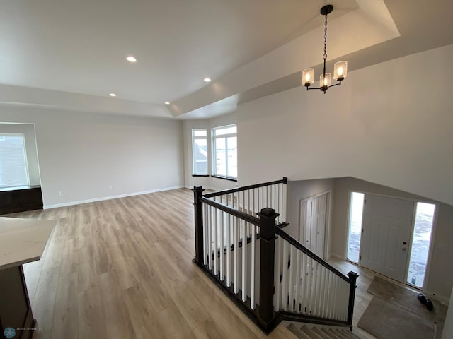 1312 Southview Dr SW, Glyndon, MN 56547 - staircase with a chandelier, a raised ceiling, wood finished floors, recessed lighting, and baseboards