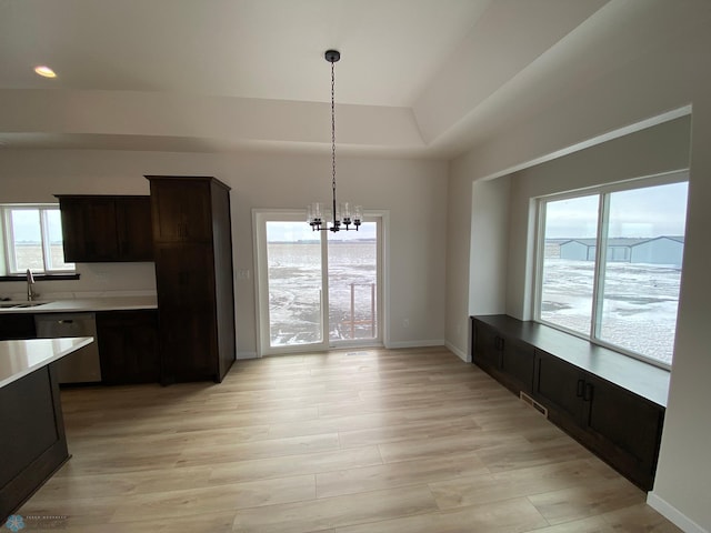 1312 Southview Dr SW, Glyndon, MN 56547 - unfurnished dining area featuring a sink, a chandelier, light wood-type flooring, and baseboards