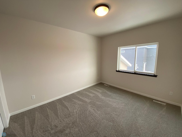 1312 Southview Dr SW, Glyndon, MN 56547 - unfurnished room with dark colored carpet and baseboards