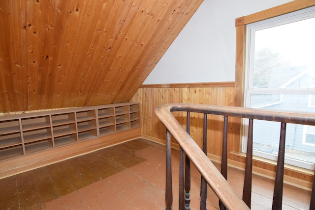 bonus room featuring lofted ceiling, wooden walls, and wood ceiling