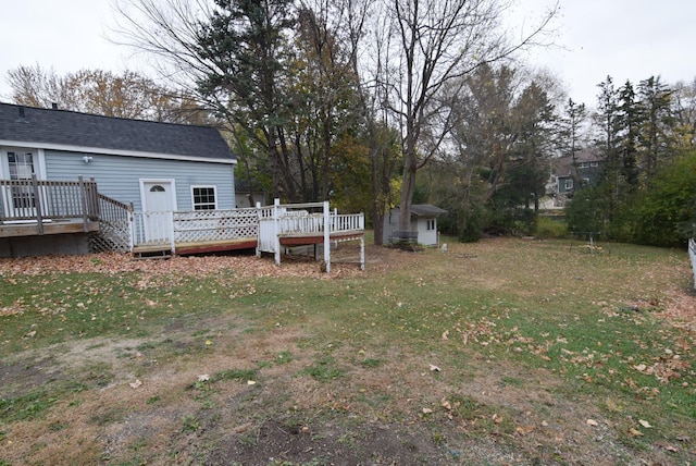 view of yard with a shed and a wooden deck