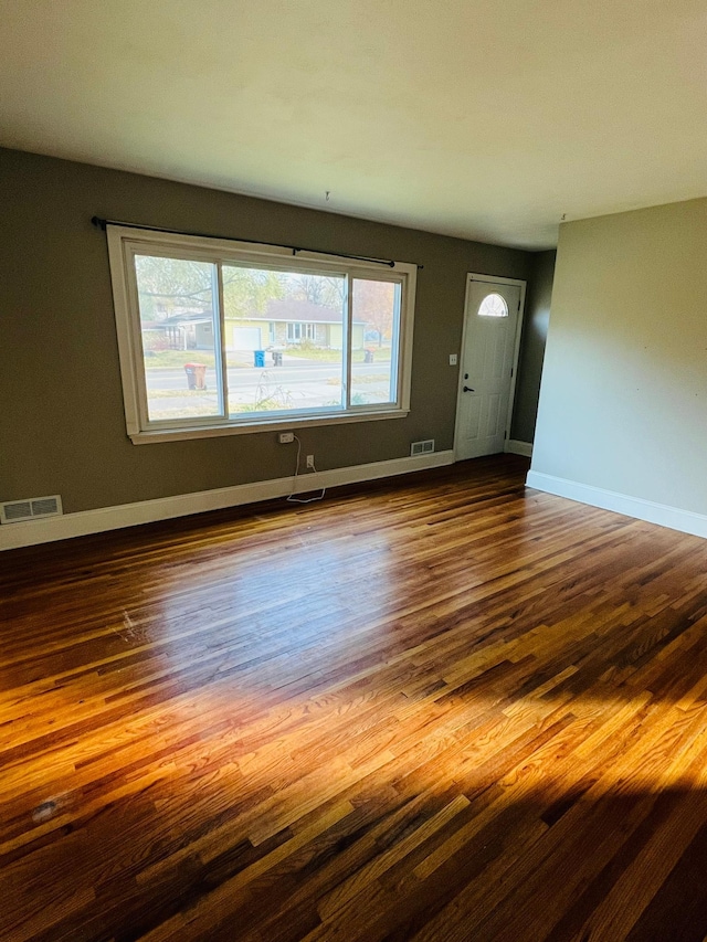 unfurnished living room with hardwood / wood-style flooring