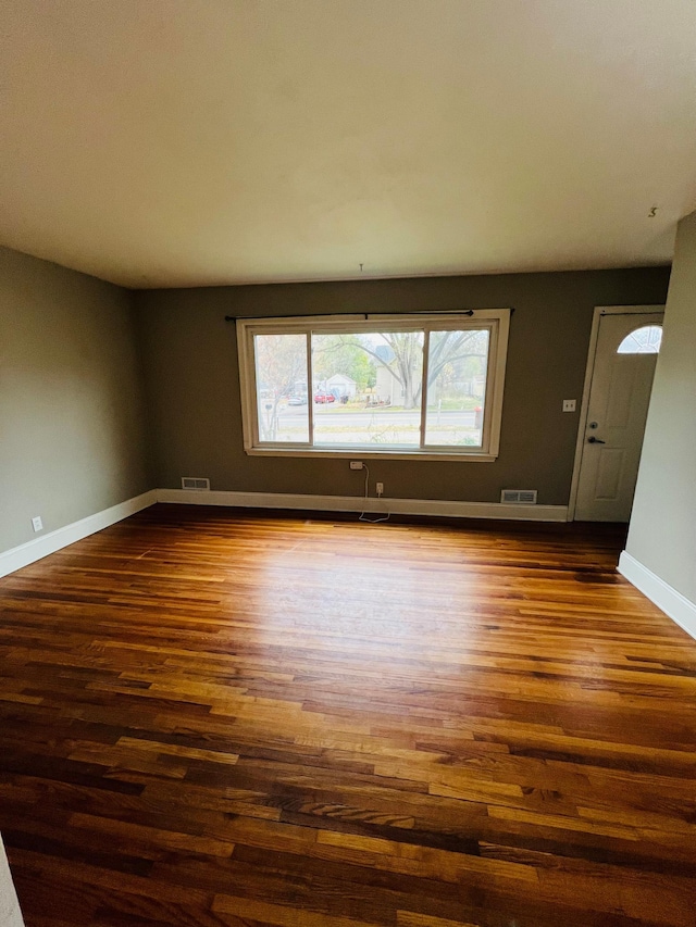 spare room featuring dark wood-type flooring