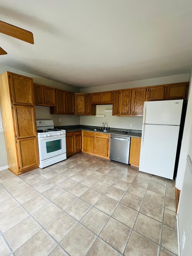 kitchen featuring light tile patterned floors, sink, white appliances, and ceiling fan