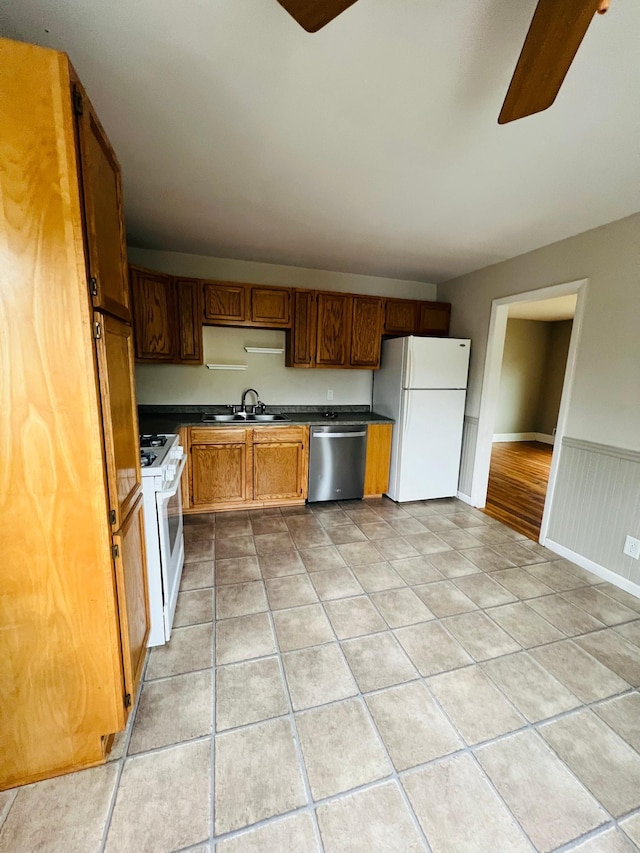 kitchen with white appliances, ceiling fan, and sink