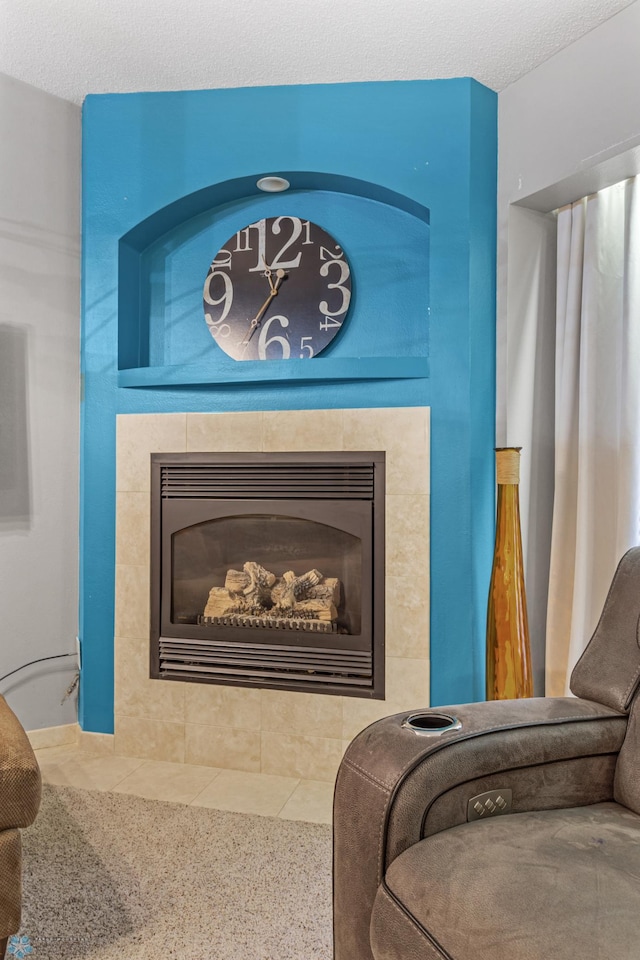 room details featuring a textured ceiling and a tile fireplace