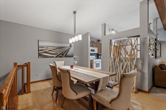 dining space featuring light wood-type flooring