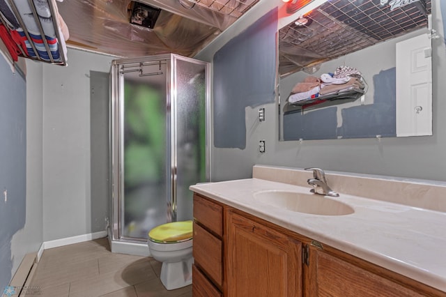 bathroom featuring a shower with shower door, vanity, toilet, and tile patterned flooring